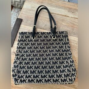 Michael Kors purse. Black monogram with gold hardware. EUC.